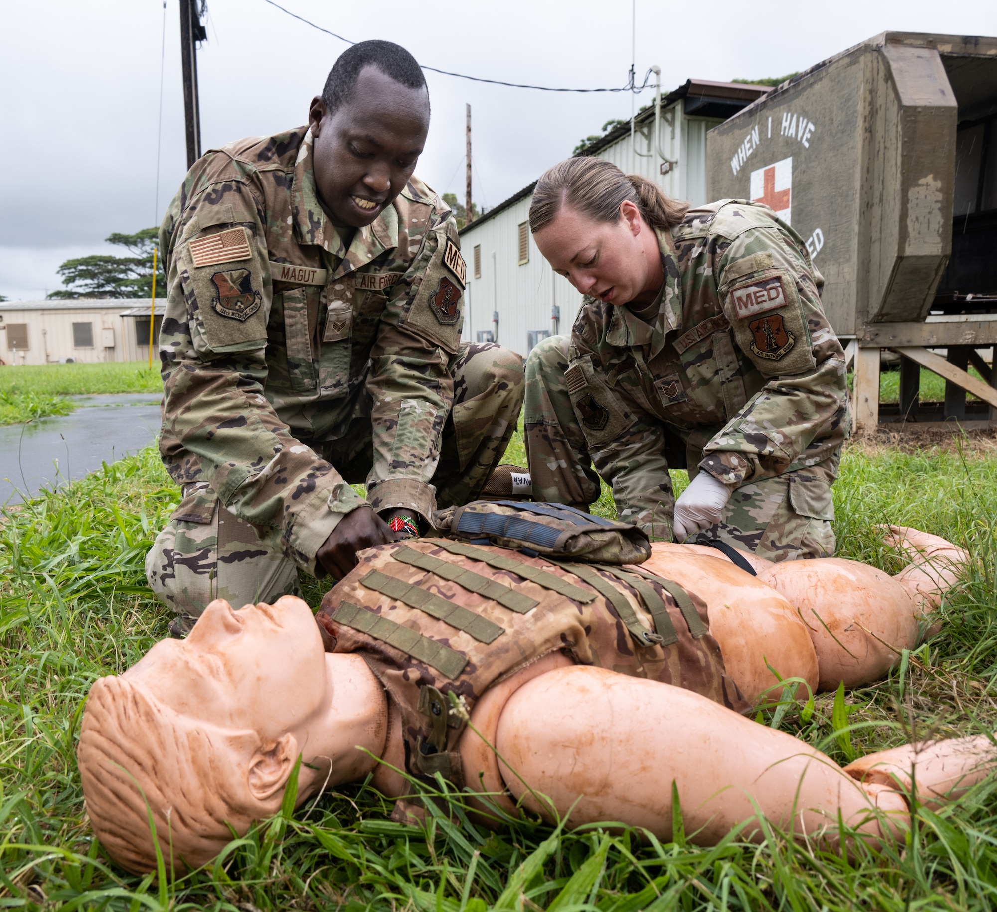 Tech. Sgt. Amanda Nichols and Senior Airman Magut Abednego, both 136th Airlift Wing aerospace medical technicians, apply emergency care to a medical grade mannequin during training at U.S. Army Installation Schofield Barracks in Hawaii May 18, 2023.