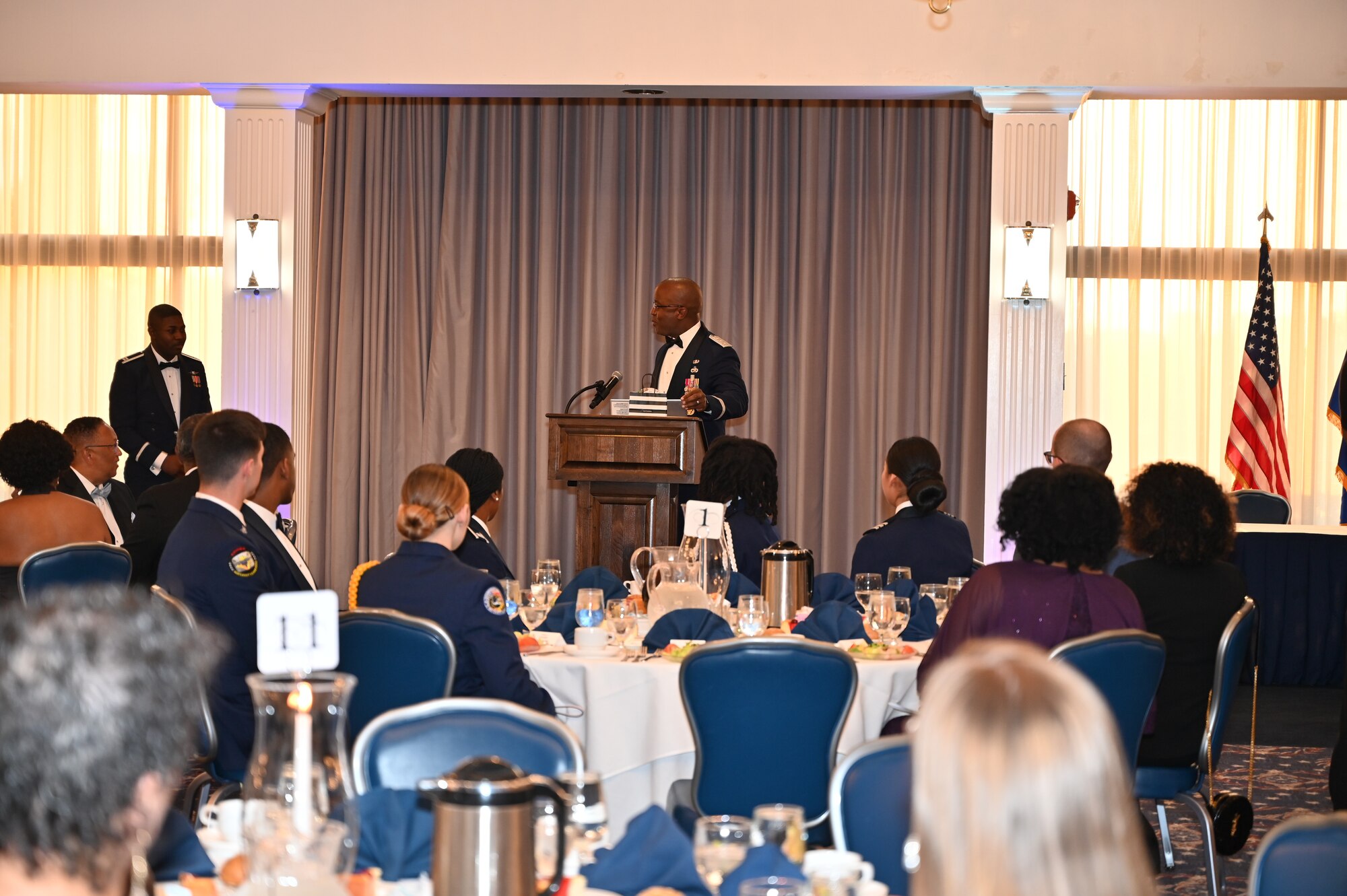 Lt. Gen. Stacy Hawkins, Air Force Sustainment Center Commander, gives the keynote speech at the 34th Annual Air Force Cadet Officer Mentor Association’s (AFCOMA) Anniversary Awards Gala to a room filled with ROTC cadets, AFCOMA members and alum, and their families on May 6, 2023, at Joint Base Anacostia-Bolling.