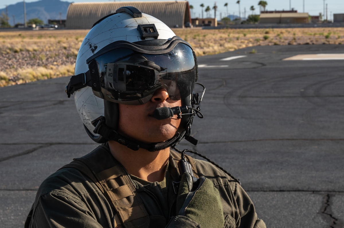 U.S. Marine Corps Lance Cpl. Anthony Sanchez, Helicopter Marine Light Attack Squadron 775, 4th Marine Air Wing, helicopter crew chief, communicates with helicopter pilots in Arizona, May 14, 2023. Sanchez took part in DoD’s premier combat search and rescue exercise, RED FLAG-Rescue 23-1. (U.S. Air Force photo by Airman 1st Class Jhade Herrera)