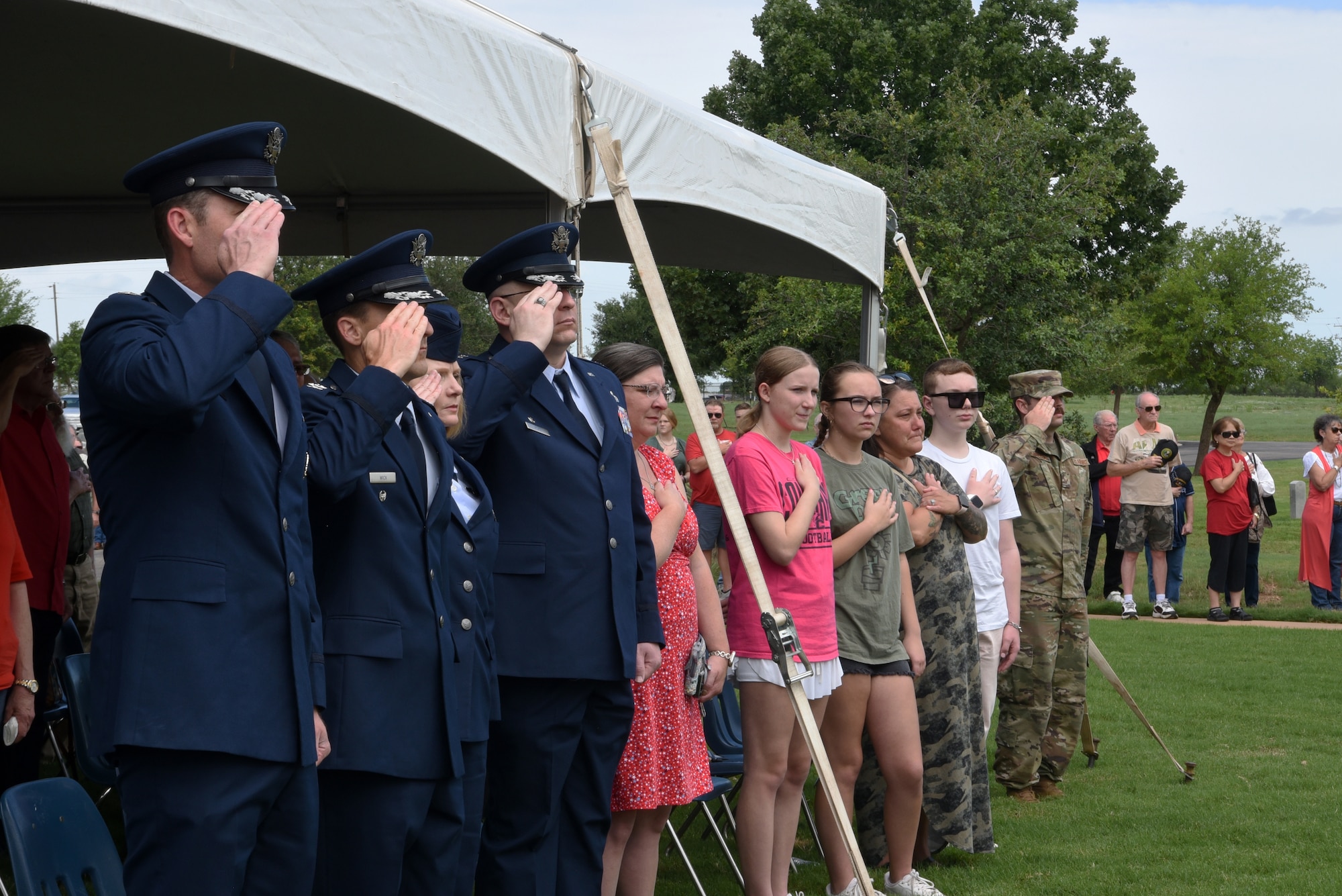 Dyess Air Force Base senior leaders salute during the playing of taps at the Texas State Veterans Cemetery in Abilene, Texas, May 29, 2023. Memorial Day is a time to honor the ultimate sacrifice of the service members that gave their lives in defense of the United States. (U.S. Air Force photo by Senior Airman Sophia Robello)