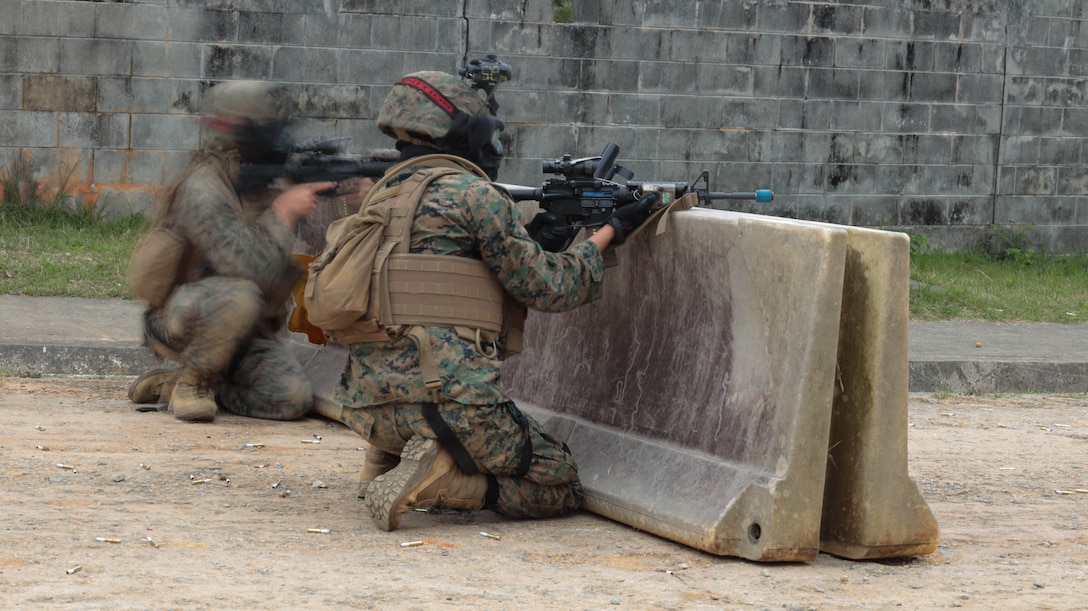 U.S. Marines with Headquarters Battalion, 3d Marine Division maintain security during Exercise Samurai 23.2 in the Central Training Area on Okinawa, Japan, April 26, 2023. Samurai 23.2 demonstrated Headquarters Battalion's ability to serve as a security force for the division in an urban environment while also enhancing their proficiency in combat tactics. (U.S. Marine Corps photo by Lance Cpl. Evelyn Doherty)