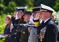 ROMAGNE-SOUS-MONTFAUCON, France (May 28, 2023) - U.S. Navy Adm. Stuart B. Munsch, commander for the U.S. Naval Forces Europe – Africa and Allied Joint Force Command Naples, along with other Admirals throughout the regions render salute during the national anthems (La Marseillaise & Star-Spangled Banner) sung by Mrs. Amy Malone at the Meuse-Argonne American Cemetery ceremony in Romagne-sous-Montfaucon, France, May 28, 2023. Admirals from the U.S. Naval Forces Europe-Africa, U.S. Sixth Fleet, and Navy Region Europe, Africa, Central traveled throughout Europe visiting American Battle Monuments Commission cemeteries to honor the lives and legacies of fallen U.S. and Allied service members who paid the ultimate price through servicing their countries. Headquarters in Naples, Italy, NAVEUR-NAVAF operates U.S. naval forces in the U.S. European Command and U.S. Africa Command area of responsibility. U.S. Sixth Fleet is permanently assigned to NAVEUR-NAVAF and employs maritime forces through the full spectrum of joint and naval operations.