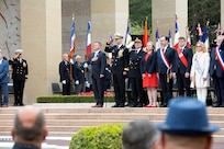 COLLEVILLE-SUR-MER, France - Rear Adm. Oliver T. Lewis, Director of Maritime Operations, U.S. Naval Forces Europe-Africa / U.S. Sixth Fleet, salutes the national ensign for the presentation of the colors during the Memorial Day commemoration ceremony honoring the American servicemembers that died in the invasion of Normandy, at the Normandy American Cemetery and Memorial in Colleville-sur-Mer, France, May 28, 2023. Admirals from U.S. Naval Forces Europe-Africa, U.S. Sixth Fleet, and EURAFCENT, traveled throughout Europe visiting American Battle Monuments Commission cemeteries to honor the lives and legacies of fallen U.S. and allied service members that paid the ultimate sacrifice in the service of their countries. Headquartered in Naples, Italy, NAVEUR-NAVAF operates U.S. naval forces in the U.S. European Command (USEUCOM) and U.S. Africa Command (USAFRICOM) areas of responsibility. U.S. Sixth Fleet is permanently assigned to NAVEUR-NAVAF and employs maritime forces through the full spectrum of joint and naval operations.