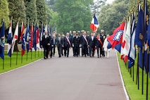 COLLEVILLE-SUR-MER, France - Rear Adm. Oliver T. Lewis, Director of Maritime Operations, U.S. Naval Forces Europe-Africa / U.S. Sixth Fleet, and other distinguished guest arrive at a Memorial Day commemoration ceremony honoring American servicemembers that died in the invasion of Normandy, at the Normandy American Cemetery and Memorial in Colleville-sur-Mer, France, May 28, 2023. Admirals from U.S. Naval Forces Europe-Africa, U.S. Sixth Fleet, and EURAFCENT, traveled throughout Europe visiting American Battle Monuments Commission cemeteries to honor the lives and legacies of fallen U.S. and allied service members that paid the ultimate sacrifice in the service of their countries. Headquartered in Naples, Italy, NAVEUR-NAVAF operates U.S. naval forces in the U.S. European Command (USEUCOM) and U.S. Africa Command (USAFRICOM) areas of responsibility. U.S. Sixth Fleet is permanently assigned to NAVEUR-NAVAF and employs maritime forces through the full spectrum of joint and naval operations.
