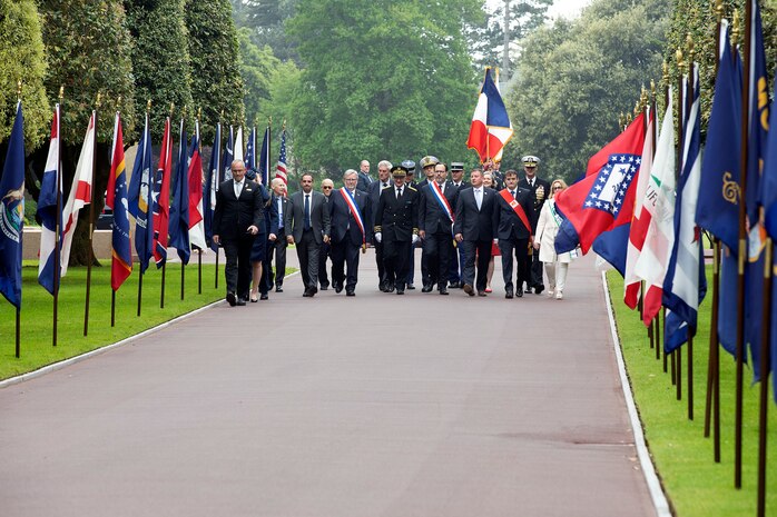 COLLEVILLE-SUR-MER, France - Rear Adm. Oliver T. Lewis, Director of Maritime Operations, U.S. Naval Forces Europe-Africa / U.S. Sixth Fleet, and other distinguished guest arrive at a Memorial Day commemoration ceremony honoring American servicemembers that died in the invasion of Normandy, at the Normandy American Cemetery and Memorial in Colleville-sur-Mer, France, May 28, 2023. Admirals from U.S. Naval Forces Europe-Africa, U.S. Sixth Fleet, and EURAFCENT, traveled throughout Europe visiting American Battle Monuments Commission cemeteries to honor the lives and legacies of fallen U.S. and allied service members that paid the ultimate sacrifice in the service of their countries. Headquartered in Naples, Italy, NAVEUR-NAVAF operates U.S. naval forces in the U.S. European Command (USEUCOM) and U.S. Africa Command (USAFRICOM) areas of responsibility. U.S. Sixth Fleet is permanently assigned to NAVEUR-NAVAF and employs maritime forces through the full spectrum of joint and naval operations.