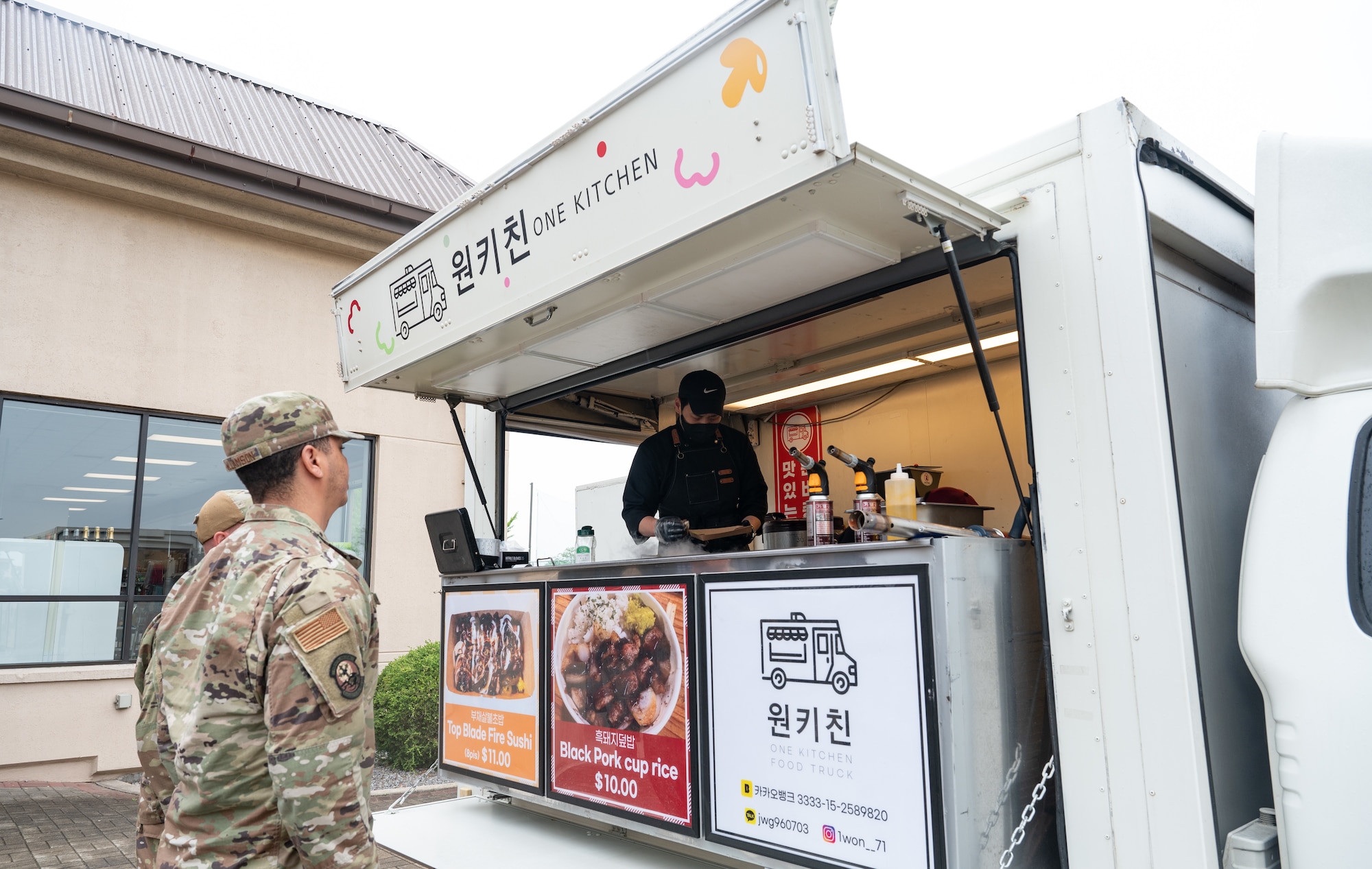 An 8th Fighter Wing Airman waits for his food at Kunsan Air Base, Republic of Korea, May 22, 2023. Adding food trucks to the lunchtime meal section was an Airmen-driven idea fronted by the Quality of Life taskforce. (U.S. Air Force photo by Staff Sgt. Sadie Colbert)