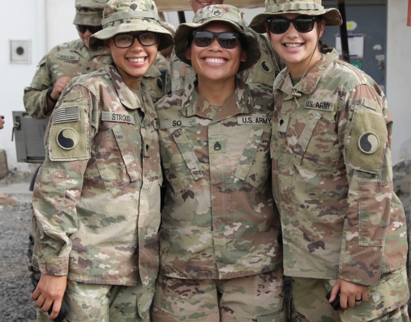 Three female Soldiers pose together.