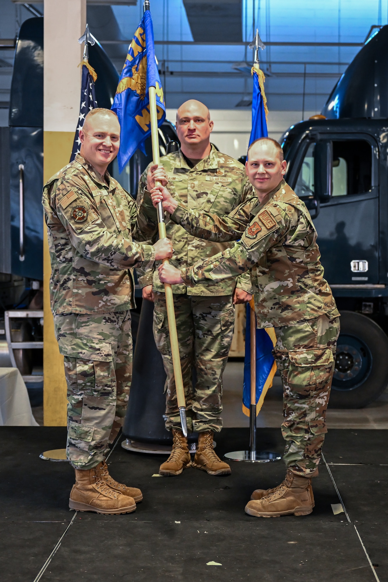 Col. Michael Power, 90th Maintenance Group commander, passes the 90th Munitions Squadron guidon to Maj. Ryan Deming, incoming 90 MUNS commander, during a change of command ceremony on F.E. Warren Air Force Base, Wyoming, May 30, 2023. A change of command represents a formal transfer of authority and responsibility from the outgoing commander to the incoming commander. (U.S. Air Force photo by Joseph Coslett Jr.)