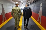 Capt. Jip Mosman, commander, Puget Sound Naval Shipyard & Intermediate Maintenance Facility, in Bremerton, Washington, tours the newly renovated Burwell Tunnel with Geno Hernandez, Sr. Visual Information Specialist, PSNS & IMF Public Affairs Office, following the ribbon-cutting ceremony May 9, 2023. Hernandez designed and illustrated the overall atheistic with added graphic embellishment created by his design partner Robin Lee, Visual Information specialist, PSNS & IMF Public Affairs Office. (U.S Navy photo by Wendy Hallmark)