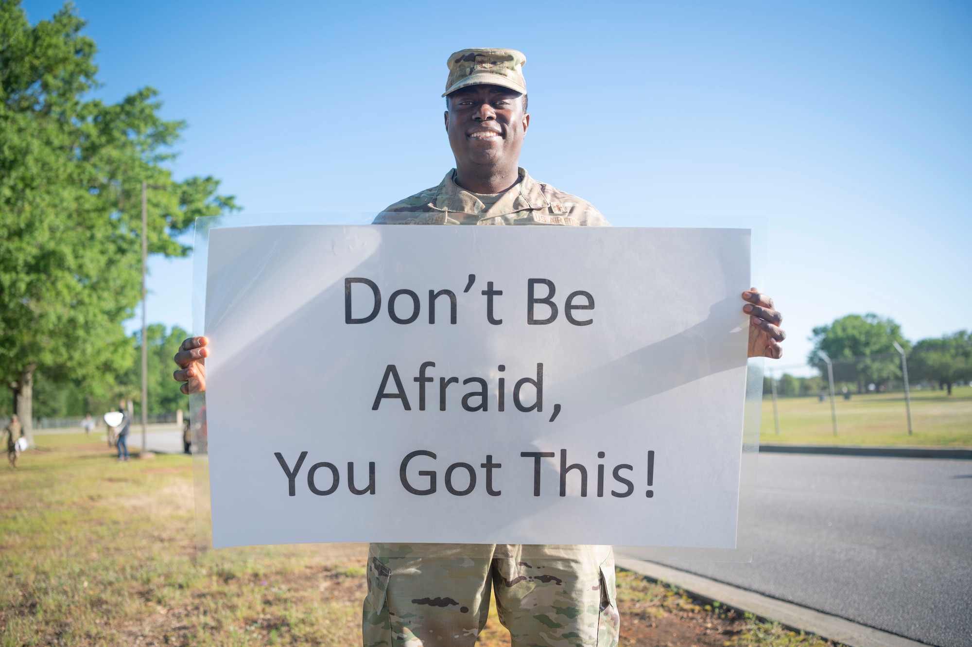 U.S. Air Force Capt. Rotimi Adedokun, 20th Maintenance Group chaplain, displays his sign for the Inspire Shaw campaign at Shaw Air Force Base, S.C., May 1, 2023. Inspire Shaw was created by Adedokun to celebrate the achievements of the Airmen at Shaw, encouraging them to further contribute to the Wild Weasel culture of looking out for one another. (U.S. Air Force photo by Senior Airman Isaac Nicholson)