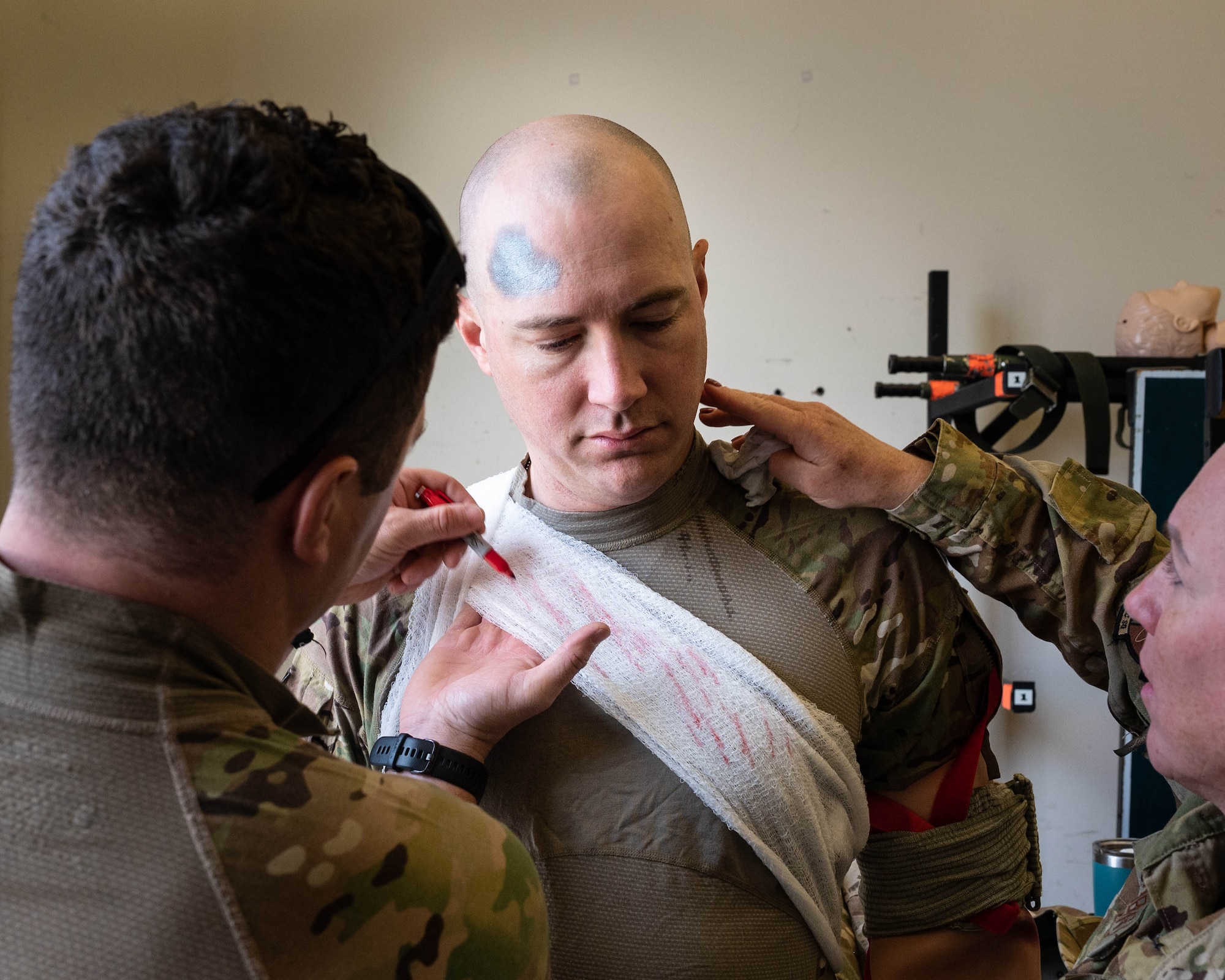 Maj. John Lunieski, a 934th Aeromedical Evacuation Squadron operations support flight commander, prepares to simulate an injured Airman in a training exercise at Minneapolis-St. Paul Air Reserve Station, May 5, 2023. Lunieski has assisted in organizing the annual joint force training exercise for over five years. (U.S. Air Force photo by Senior Airman Victoriya Tarakanova)