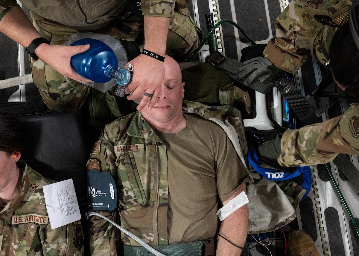 Capt. Loren Sadlack, a 934th Aeromedical Evacuation Squadron readiness officer, receives care as a simulated patient during a training exercise at the Minneapolis-St. Paul Air Reserve Station, May 5, 2023. Medically-trained Airmen were responsible for transferring, stabilizing and treating approximately 20 patients during the exercise. (U.S. Air Force photo by Senior Airman Victoriya Tarakanova)