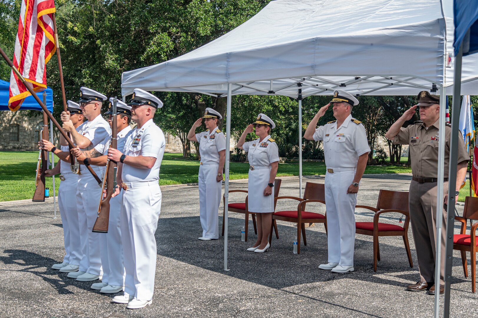 CAPT Walter D. Brafford (2nd from right), incoming commander, salutes during the National Anthem with Rear Adm. Cynthia A. Kuehner (2nd from left), Rear Adm. Anne Swap (left) and Army Lt. Gen. John P. Evans Jr.