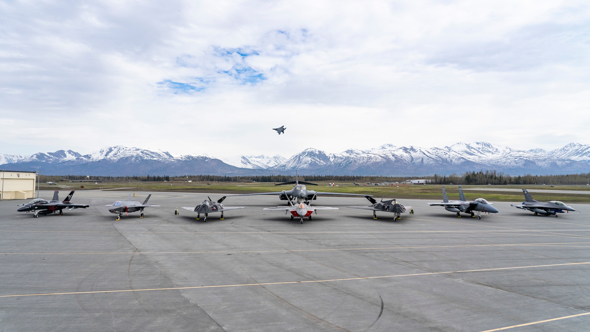 From left to right, a U.S. Navy EA-18G “Growler” assigned to the Air Test and Evaluation Squadron Nine (VX-9), U.S. Air Force F-35A Lightning II assigned to the 422d Test and Evaluation Squadron, U.S. Air Force F-117 Nighthawk, U.S. Air Force F-22 Raptor assigned to the 3rd Wing, U.S. Air Force B-1b Lancer (back) assigned to the 85th Test and Evaluation Squadron, U.S. Air Force F-15EX assigned to the 53rd Wing and a U.S. Air Force F-16C Fighting Falcon assigned to the 422nd Test and Evaluation Squadron, are lined up on the flightline during Northern Edge 23-1 at Joint Base Elmendorf-Richardson, Alaska, May 18, 2023. NE 23-1 provides an opportunity for joint, multinational and multi-domain operations designed to implement high-end, realistic war fighter training, develop and improve joint interoperability, and enhance the combat readiness of participating forces. (U.S. Air Force photo by Airman 1st Class Shelimar Rivera Rosado)