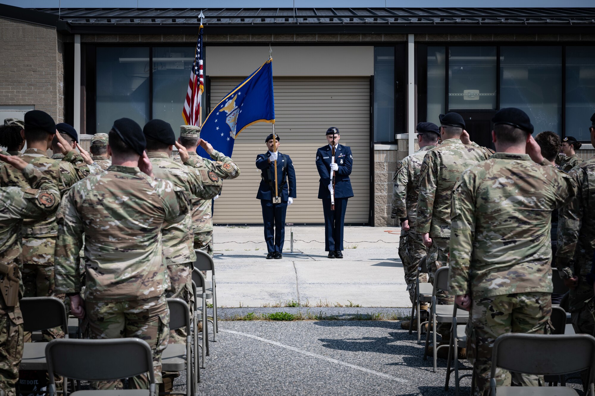 Airmen assigned to the 436th Security Forces Squadron salute the United States flag at the 2023 Police Week opening ceremony at Dover Air Force Base, Delaware, May 22, 2023. In recognition of Police Week, the 436th SFS held a ruck, excellence in competition event, Defender’s Challenge and a golf tournament. Police Week recognizes fallen law enforcement officers, including security forces members. (U.S. Air Force photo by Staff Sgt. Marco Gomez)