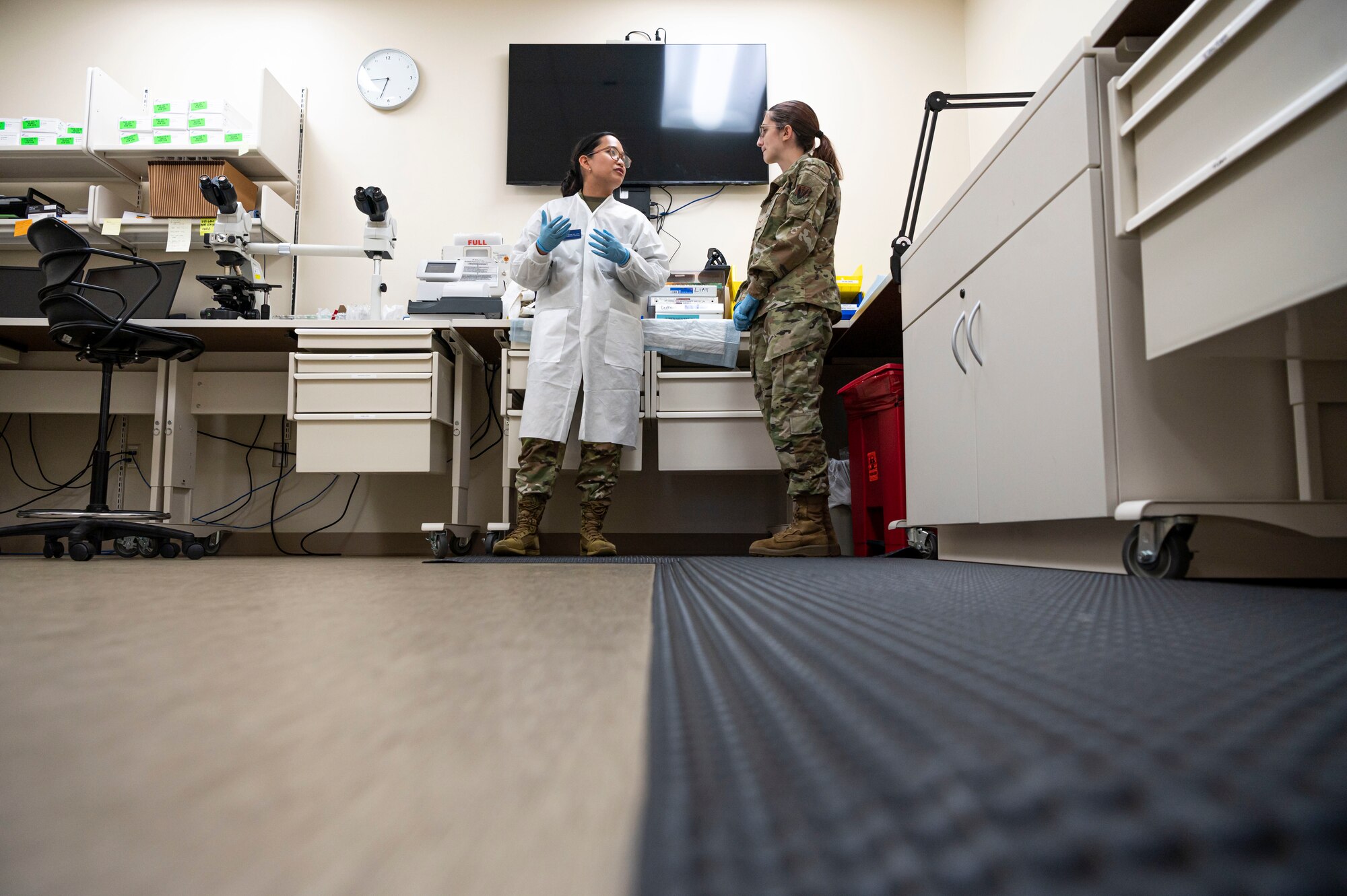 U.S. Air Force Senior Airman Apple Alterado, 20th Healthcare Operations Squadron (HCOS) medical laboratory technician, left, gives a tour of the urology lab to Airman 1st Class Hannah Trent, 20th Operational Medical Readiness Squadron aerospace medical services technician, during Lab Week at Shaw Air Force Base, S.C., April 26, 2023. The 20th HCOS provides urology services to monitor the health of Team Shaw so that they can remain ready to fly, fight and win. (U.S. Air Force photo by Senior Airman Isaac Nicholson)