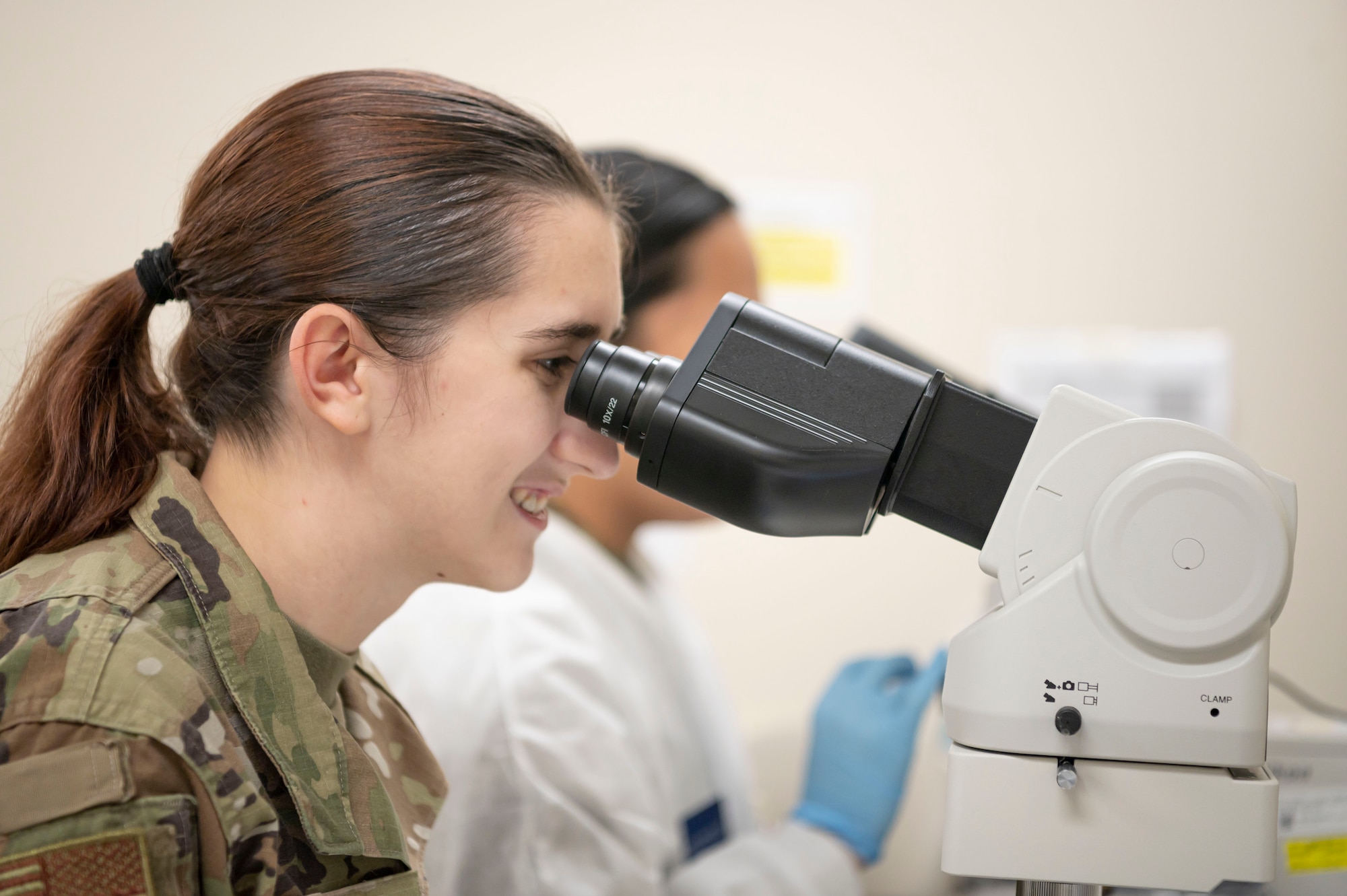 U.S. Air Force Airman 1st Class Hannah Trent, 20th Operational Medical Readiness Squadron aerospace medical services technician, looks through a microscope during Lab Week at Shaw Air Force Base, S.C., April 26, 2023. The disease detection work of the 20th Healthcare Operations Squadron helps Team Shaw remain a healthy fighting force, prepared to complete combat missions at all times. (U.S. Air Force photo by Senior Airman Isaac Nicholson)