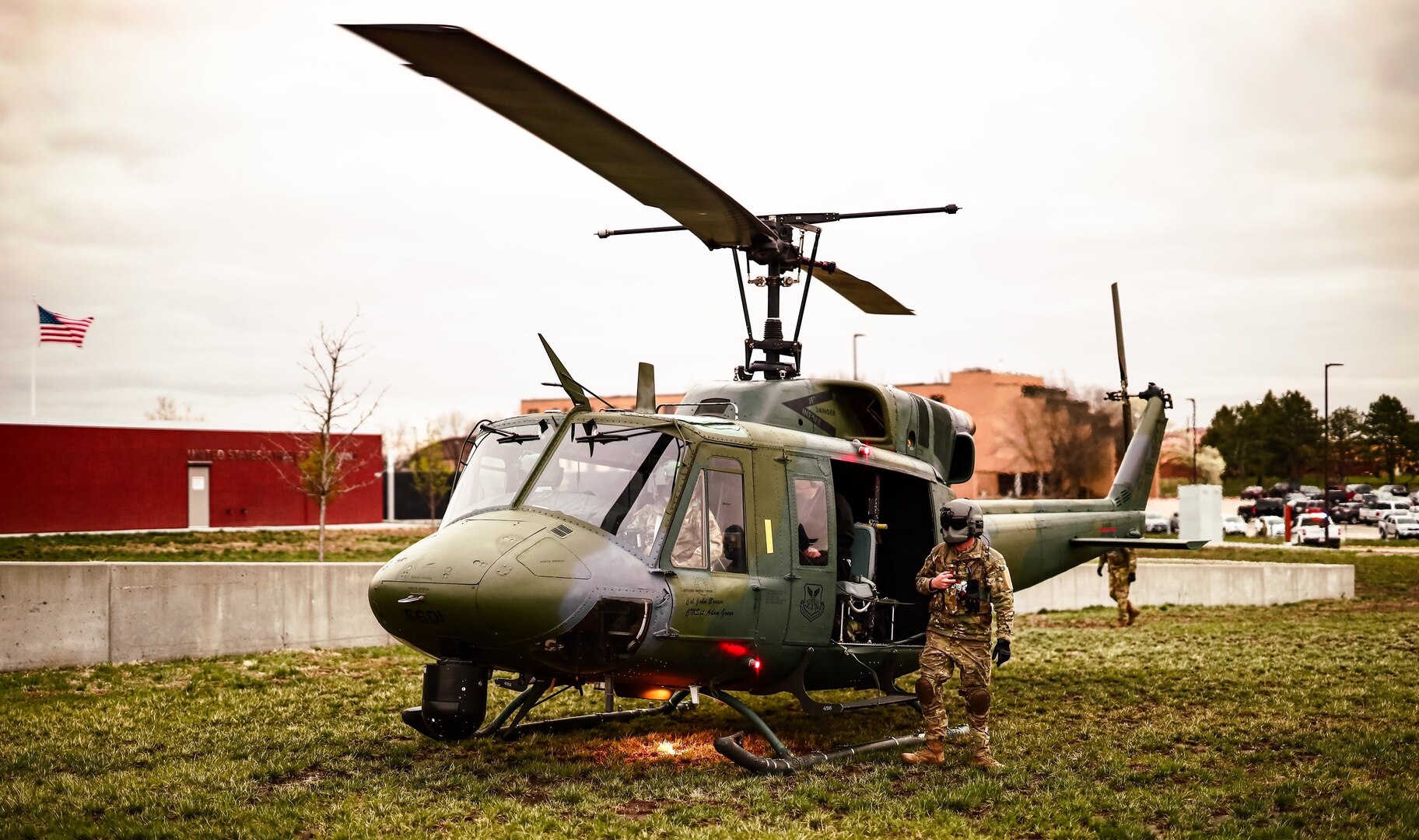 flight engineer secures helicopter passengers