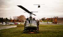 one helicopter on ground, one in air