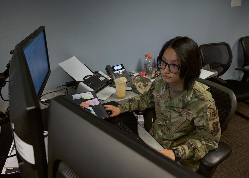 U.S. Air Force Airman 1st Class Lammy Vong, 5th Comptroller Squadron financial operations technician, works on financial forms at Minot Air Force Base, North Dakota, May 25, 2023. Vong says that her upbringing in Vietnam taught her discipline, and was influential in enabling her to scan through documents for errors. (U.S. Air Force photo by Airman 1st Class Alexander Nottingham)