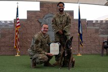 People and dog posing