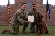 People and dog posing