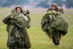 Japan Ground Self-Defense paratroopers with the 1st Airborne Brigade carry his parachute during the Japanese-American Friendship Festival 2023 at Yokota Air Base, Japan, May 21, 2023. Paratroopers from the U.S. Army 1st SFG (Airborne), USAF 320th Special Tactics Squadron, and JGSDF 1st Airborne Brigade conducted static-line jump demonstrations to show their capabilities during the festival. During the two-day festival, 193,000 attendees came to Yokota to experience the event. The festival is aimed at increasing bilateral relationships between U.S. and Japanese communities and allows people to see U.S. and Japanese military capabilities first-hand. (U.S. Air Force photo by Yasuo Osakabe)