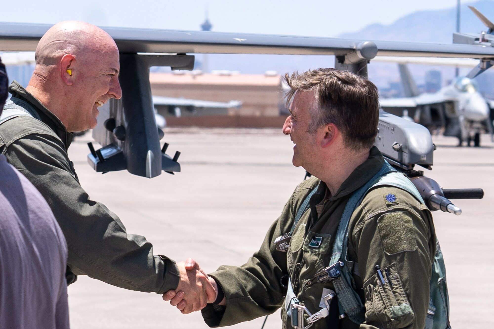 Mr. Rob McHenry, the Deputy Director of the Defense Advanced Research Projects Agency (DARPA), left, and U.S. Air Force Lt. Col. Dustin Sanders, deputy commander of the 422 Test and Evaluations Squadron, meet after a familiarization flight at Nellis Air Force Base, Nevada, May 24, 2023.