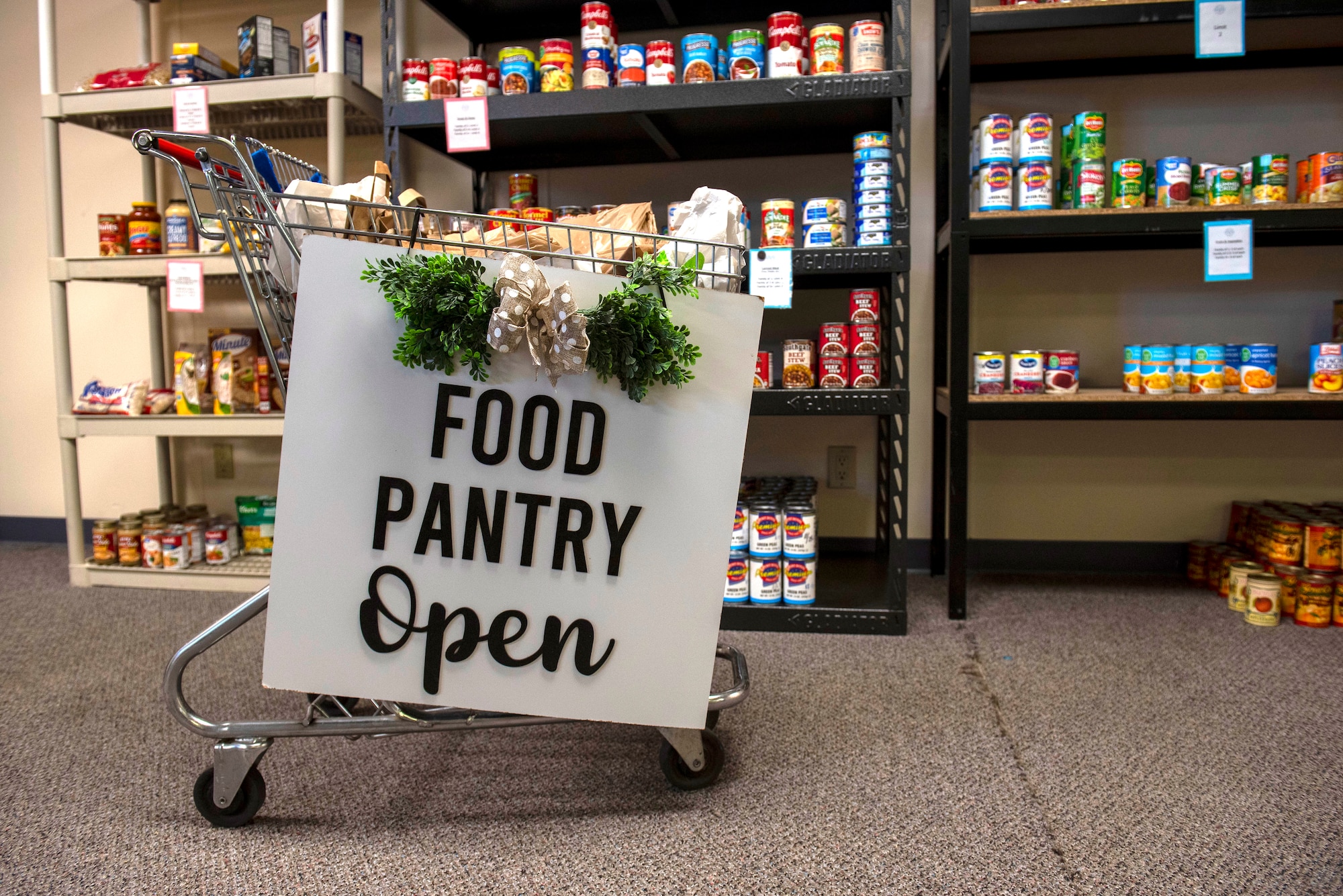 A welcome sign is on display at the Fairchild Food Pantry at Fairchild Air Force Base, Washington, May 25th, 2023. A wide variety of unperishable goods, toiletries, baby supplies, and pet food is offered to Airmen and their families free of charge. (U.S. Air Force photo by Airman 1st Class Lillian Patterson)