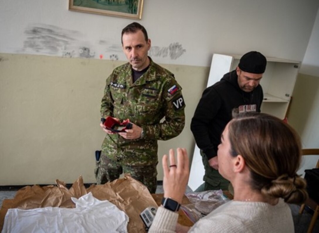 Lt. Col. Marek Hušek, Ministry of Defense of the Slovak Republic director of operations, training, and planning, listens as Special Agent Cristin O'Malley, OSI Det. 515 senior enlisted leader, shares OSI's practices for crime scene investigations during a multi-day information exchange in Hronsek, Slovakia. The event involved OSI and military police from Eastern European nations, such as Slovakia and the Czech Republic. (U.S. Air Force photo by Thomas Brading, OSI/PA)