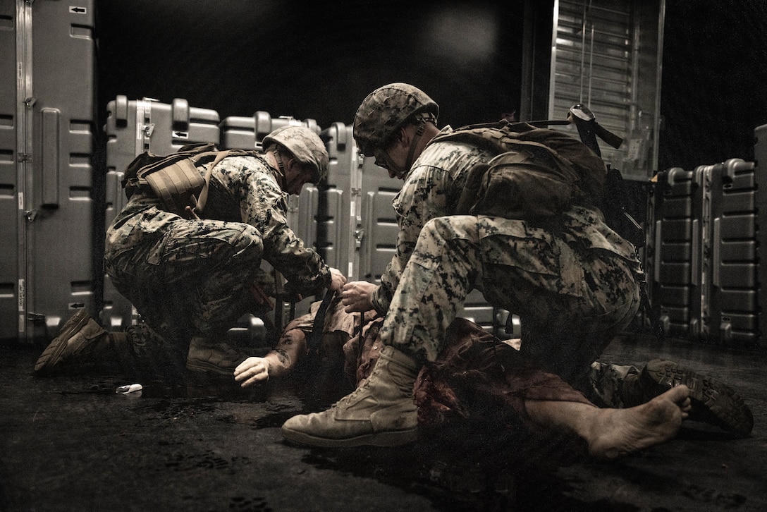 U.S. Navy sailors and Marines with 2d Marine Division participate in a simulated tactical combat casualty care scenario during the Doc Kent Competition on Camp Lejeune, North Carolina, May 26, 2023. The competition showcases the capabilities of executing tactical combat casualty care in austere environments by utilizing various evacuation platforms to move from point of injury to higher echelons of care.