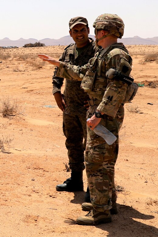 First Lt. Derrick Alvarez, right, executive officer with C Battery, 1-107th Field Artillery Regiment, 2nd Infantry Brigade Combat Team, 28th Infantry Division confers with his Tunisian armed forces counterpart during African Lion 23, May 27, 2023 at Ben Ghilouf Training Area, Tunisia. One of the priorities of the U.S. partnership with Tunisia is to help Tunisia provide a stable and secure environment conducive to the development of democratic institutions and practices. Eighteen nations and approximately 8,000 personnel will participate in African Lion 23, U.S. Africa Command's largest annual combined, joint exercise that will take place in multiple countries to include Tunisia from May 13 - June 18, 2023. (U.S. Army photo by 1st Sgt. HollyAnn Nicom)