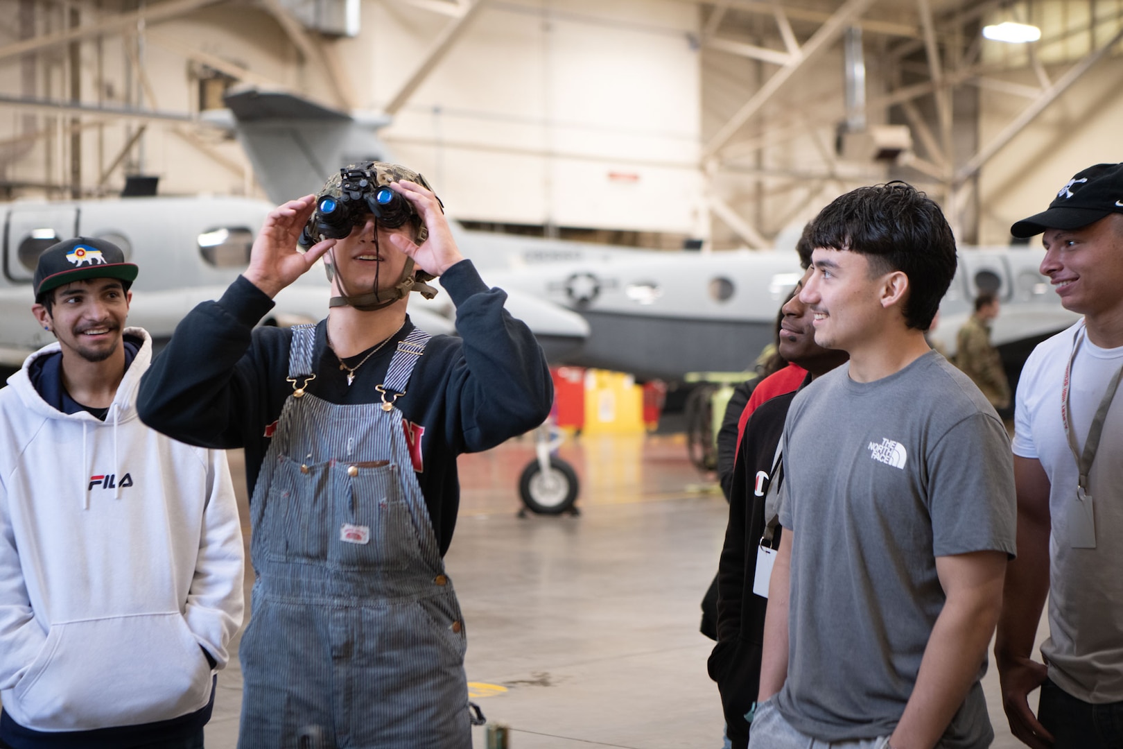 high school students look through night vision goggles excitedly