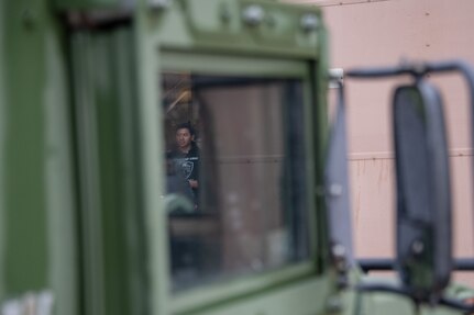 a high school student is seen through the window of a Humvee
