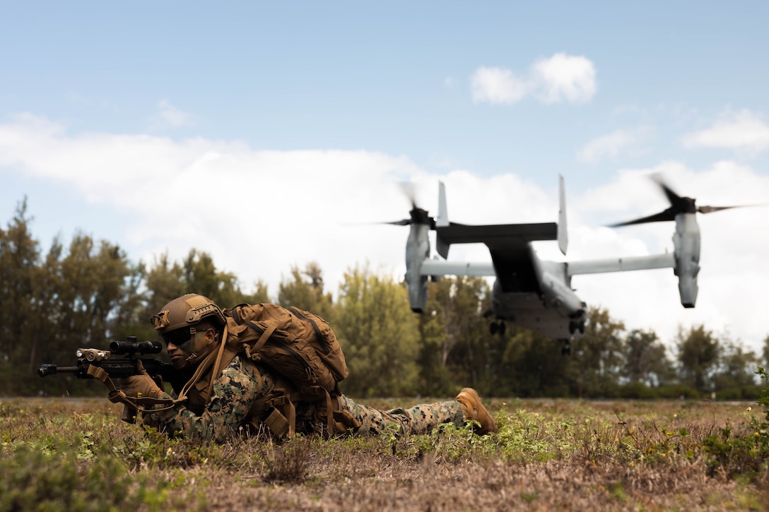 U.S. Marine Corps Lance Cpl. Efren Bonilla-Perez sets security for an MV-22 Osprey with Marine Medium Tilt Rotor Squadron (VMM) 268, Marine Aircraft Group 24, 1st Marine Aircraft Wing, during Force Design Integration Exercise at Dillingham Airfield, Sept. 26, 2023. Force Design Integration Exercise demonstrates the current capabilities of 3d Marine Littoral Regiment as an effective part of the Stand-In Force integrated with our Pacific Marines and Joint counterparts. Through the demonstration of Force Design 2030-enabled capabilities, 3d MLR showcases the implementation of technology, doctrine, and policy initiatives to allow the SiF to sense and make sense of potential adversaries, seize and hold key maritime terrain, and conduct reconnaissance and counter-reconnaissance. Bonilla-Perez is a rifleman with 3d Littoral Combat Team, 3d MLR, 3d Marine Division and is a native of Woodstock, Georgia.