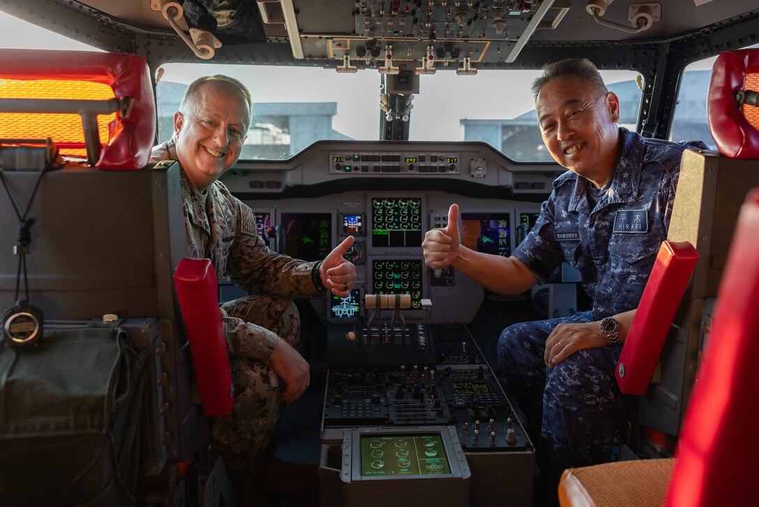 U.S. Navy Rear Adm. Darin Via, Acting Surgeon General of the Navy, left, poses for a photo with Japan Maritime Self-Defense Force Rear Adm. Takuhiro Hiragi, commander of Fleet Air Wing 31, at Marine Corps Air Station Iwakuni, Japan, October 17, 2023. During his visit to MCAS Iwakuni, Via met with station leadership and members of the Japan Maritime Self-Defense Force, toured the station’s health clinic, and hosted a town hall with naval personnel about naval medical readiness and training. (U.S. Marine Corps photo by Isaac Orozco)