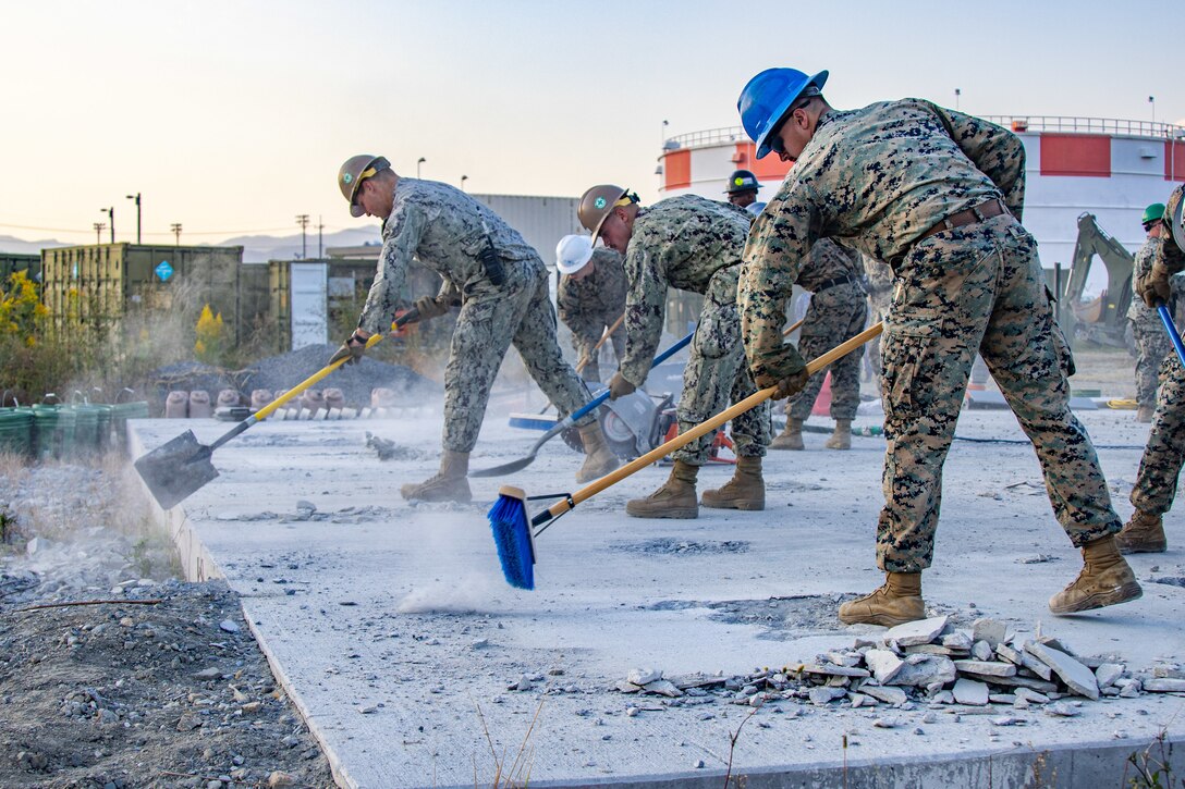 U.S. Marines with Marine Wing Support Squadron 171, Marine Aircraft Group 12 and U.S. Sailors with Headquarters and Headquarters Squadron, Marine Corps Air Station Iwakuni, clear debris from a training site during Exercise Active Shield 23 at Marine Corps Air Station Iwakuni, Japan, Oct. 25, 2023. Active Shield is an annual exercise designed to test and improve the air station’s response during base defense operations of MCAS Iwakuni and other installations in the region to sustain military operations and support the U.S.-Japan Alliance. (U.S. Marine Corps photo by Cpl. Darien Wright)