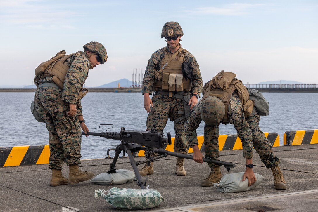 U.S. Marine Corps military police officers with the Provost Marshal’s Office, Headquarters and Headquarters Squadron, Marine Corps Air Station Iwakuni, secure an M2 machine gun with sandbags during Exercise Active Shield 23 at MCAS Iwakuni, Japan, Oct. 24, 2023. Active Shield is an annual exercise designed to test and improve the air station’s response during base defense operations of MCAS Iwakuni and other installations in the region to sustain military operations and support the U.S.-Japan Alliance. (U.S. Marine Corps Photos by Cpl. Calah Thompson)