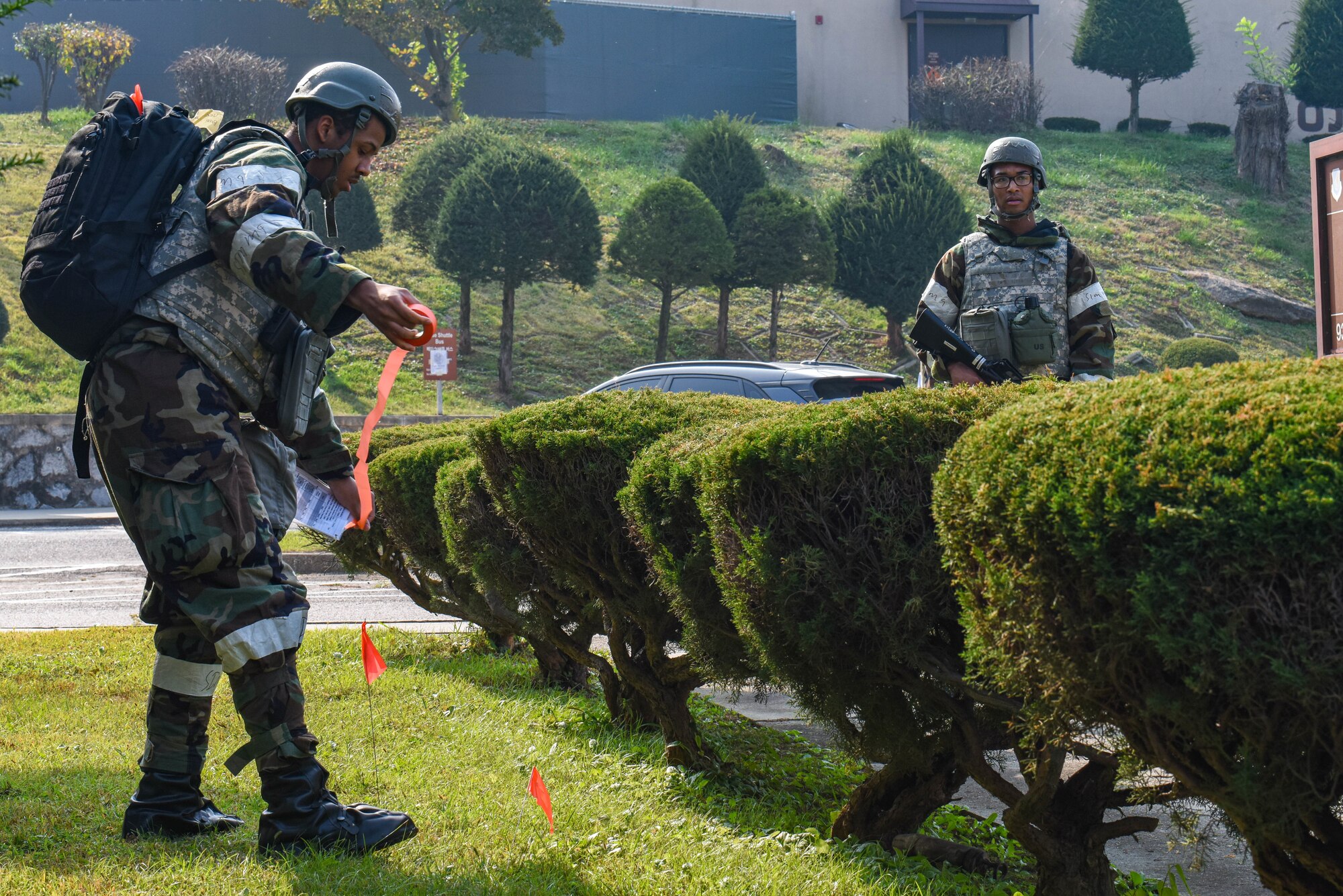 U.S. Air Force Airman 1st Class Dana Washington, left, and Airman 1st Class Eric Garrison, 51st Fighter Wing post attack reconnaissance team members, cordon off a simulated unexploded ordinance during Vigilant Defense 24 at Osan Air Base, Republic of Korea, Oct. 31, 2023. VD24 is a routine training event that tests the military capabilities across the peninsula, allowing combined and joint training at both the operational and tactical levels. Training is continuously conducted to generate combat airpower at a moment’s notice, affirming the commitment to the Republic of Korea remains ironclad and ensures regional stability throughout the Indo-Pacific. (U.S. Air Force photo by Airman 1st Class Chase Verzaal)