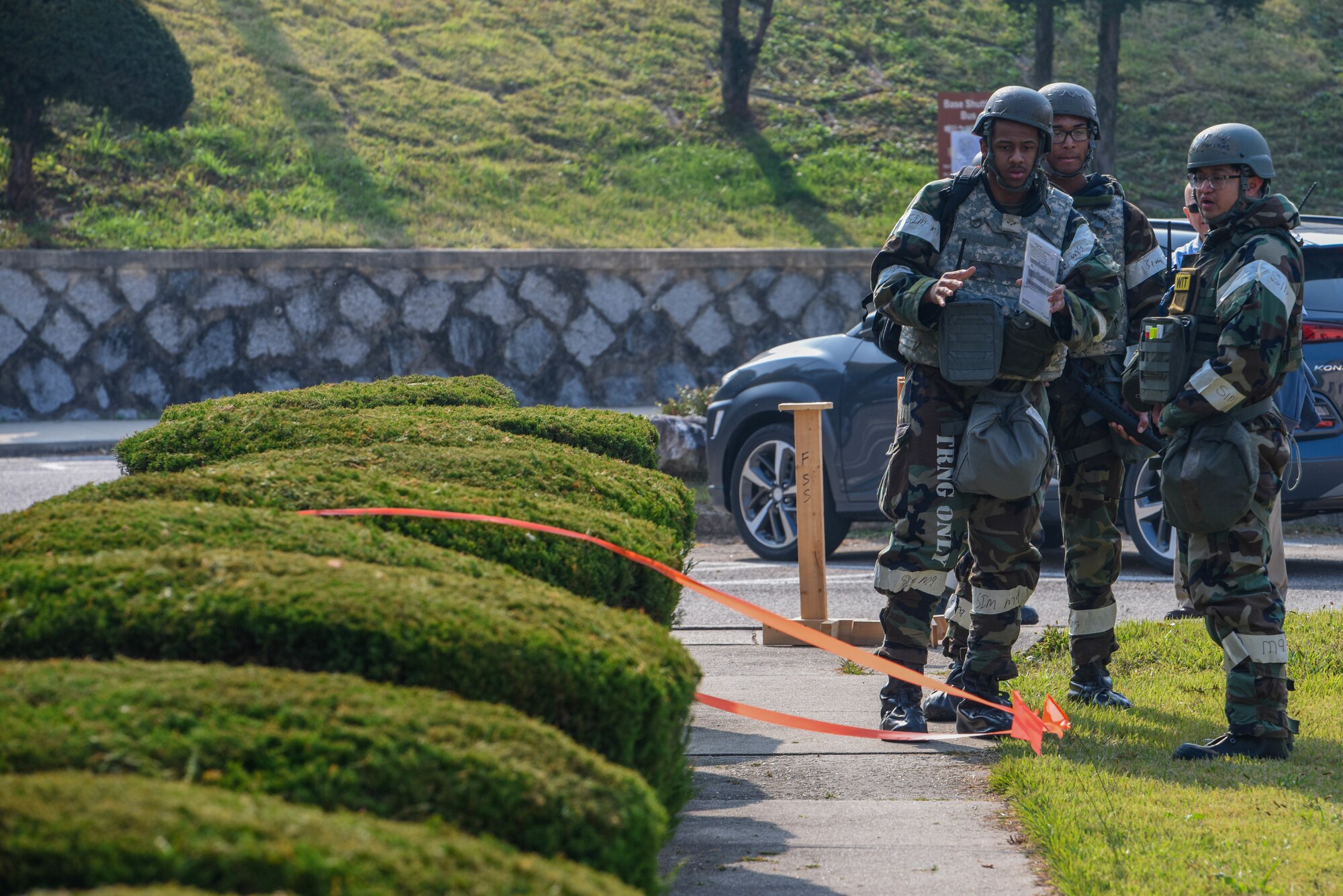 U.S. Air Force Airman 1st Class Dana Washington, left, and Airman 1st Class Eric Garrison, 51st Fighter Wing post attack reconnaissance team members, and Tech. Sgt. John Noveras, 51st FW inspection team member, discuss unexploded ordinance procedures during Vigilant Defense 24 at Osan Air Base, Republic of Korea, Oct. 31, 2023. The Airmen of the 51st FW are multi-capable and adaptive problem solvers, who are innovative and courageous, and demonstrate the value in diversity of thought, ingenuity, and initiative. VD24 is a routine training event that tests the military capabilities across the peninsula, allowing combined and joint training at both the operational and tactical levels. (U.S. Air Force photo by Airman 1st Class Chase Verzaal)