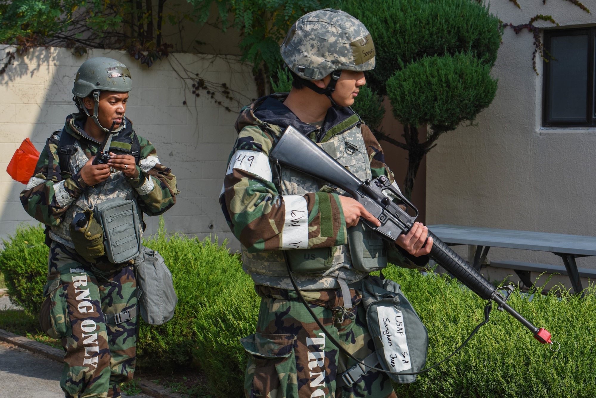 U.S. Air Force Staff Sgt. Mary Louise Van Diver, left, and Senior Airman Sanghun Jung, 51st Fighter Wing post attack reconnaissance team members, scan the area for simulated unexploded ordinance during Vigilant Defense 24 at Osan Air Base, Republic of Korea, Oct. 31, 2023. As the most forward deployed, permanently based wing in the air force, the 51st FW is charged with providing mission-ready Airmen to execute combat operations and receive follow-on forces. VD24 is a routine training event that tests the military capabilities across the peninsula, allowing combined and joint training at both the operational and tactical levels. (U.S. Air Force photo by Airman 1st Class Chase Verzaal)