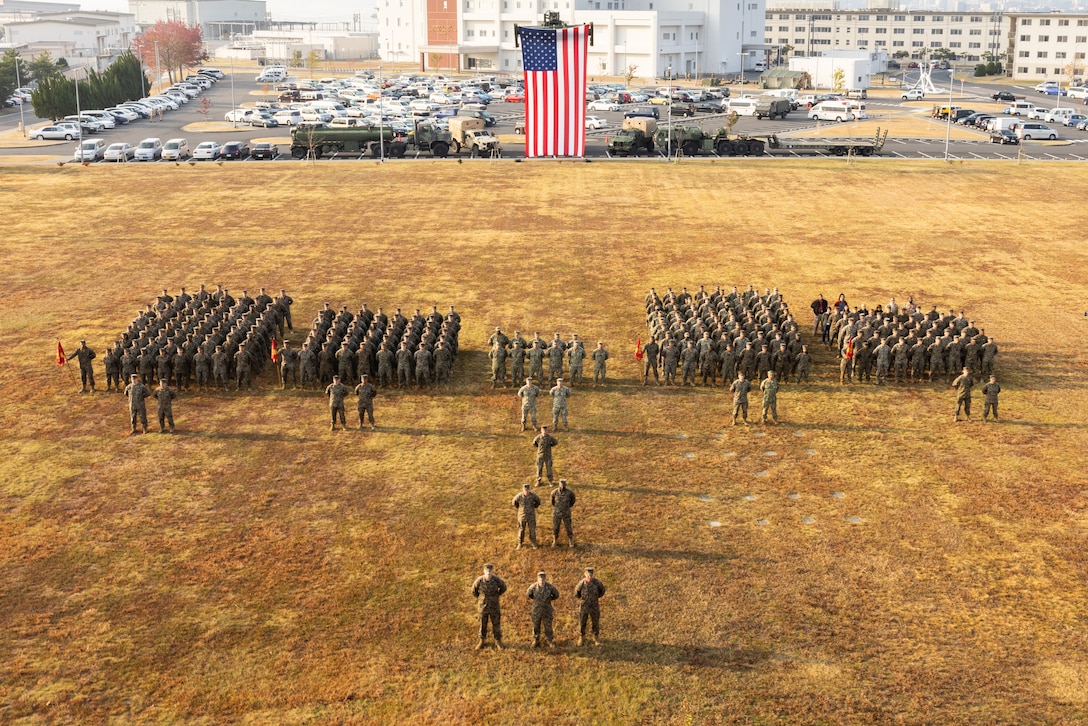 U.S. Marines and Sailors assigned to Headquarters and Headquarters Squadron, Marine Corps Air Station Iwakuni, pose for a group photo at the closing ceremony of exercise Active Shield 23 at MCAS Iwakuni, Japan, Oct. 27, 2023. Active Shield is an annual exercise designed to test and improve the air station’s response during base defense operations of MCAS Iwakuni and other installations in the region to sustain military operations and support the U.S.-Japan Alliance. (U.S. Marine Corps photo by Cpl. Isaac Orozco)