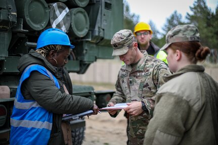 Holly Jordan from the Army Field Support Battalion-Germany goes over a hand receipt with an officer from 1st Battalion, 182nd Field Artillery Regiment, as she helps to sign over 400 pieces of equipment – to include High Mobility Artillery Rocket Systems – to the unit for DEFENDER 23 in Adazi, Latvia, earlier this year. (Sgt. Andrew Jo)