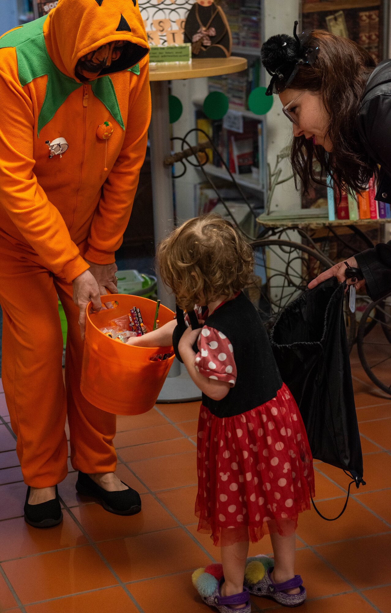 A volunteer hands out candy.