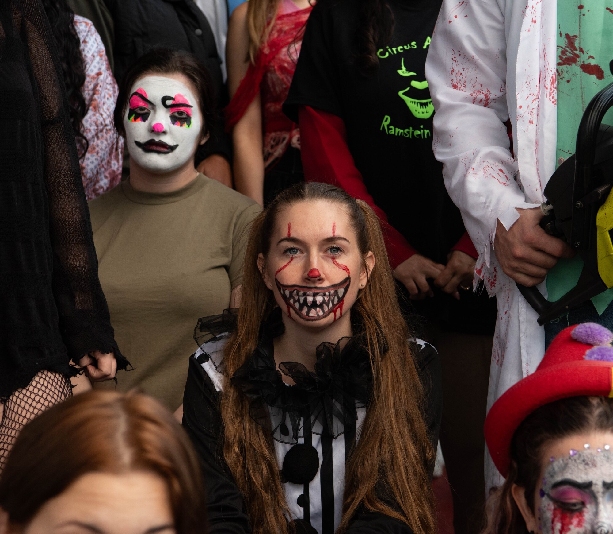 A scare actor sits.