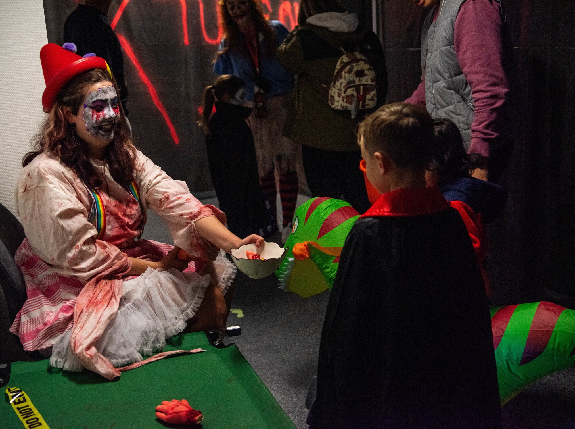A scare actor hands out candy.