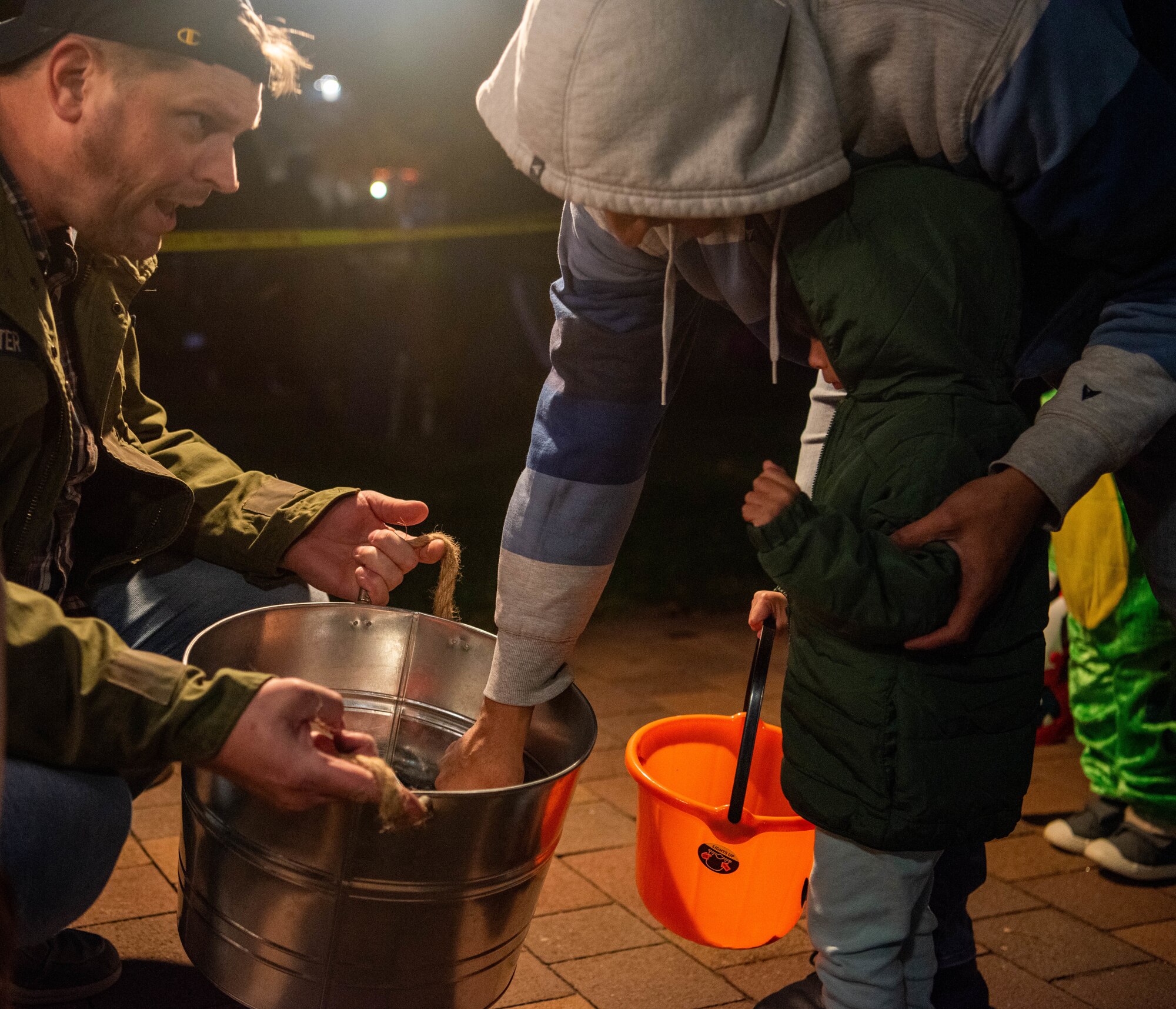 Kaiserslautern Military Community member hands out candy.