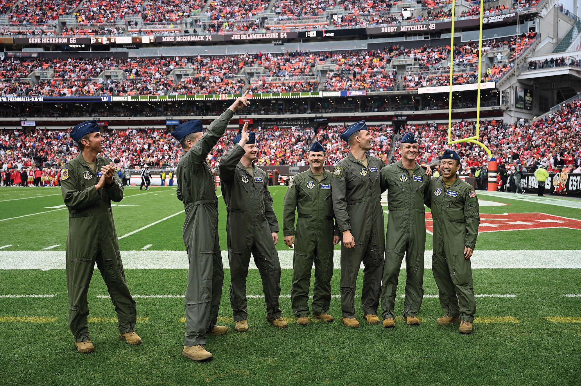 Airmen with the 89th Airlift Squadron take to the field at the Cleveland Browns Stadium, Ohio, after a flyover Oct. 15, 2023. Flyovers provide another avenue for crews to train aboard the C-17 Globemaster III aircraft, honing their skills and showcasing the aircraft’s capabilities to millions across the country. (U.S. Air Force photo/Master Sgt. Patrick O’Reilly)