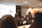 Naval Undersea Warfare Center Division, Keyport Quality Assurance Specialist Bill Longworth addresses the topic of service animal etiquette during the command’s 2023 National Disability Employment Awareness Month observance, Oct. 24.