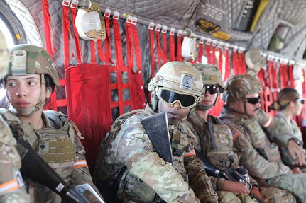 Soldiers and Airmen from the California National Guard fly in a CH-47 Chinook helicopter over Camp San Luis Obispo, Calif. on day two of the 2024 Best Warrior Competition, Oct. 24, 2023.